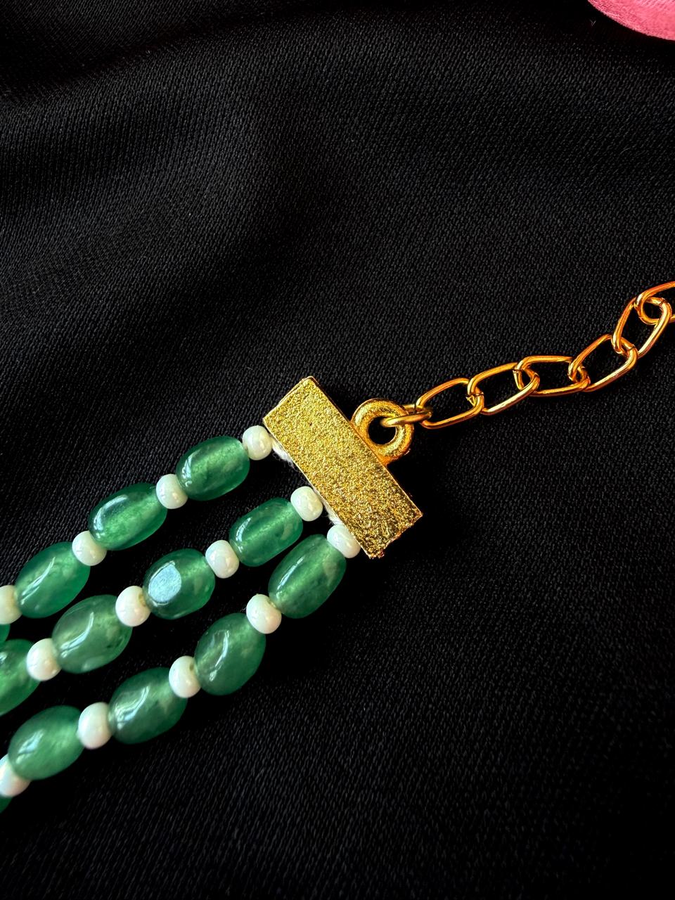 Green beaded necklace with a gold clasp
